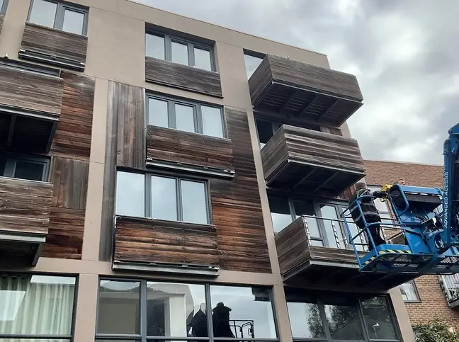 Residential block with welded balconies and wooden facades, 24 Hour Welding